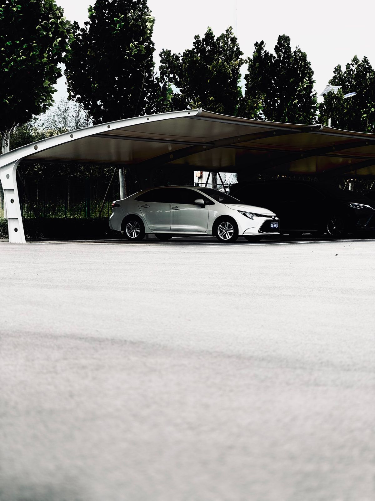 Car parked under a modern carport canopy